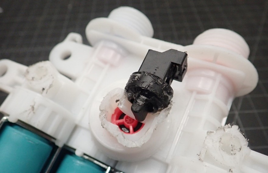 Solenoid valves control the amount of water going in and out of an appliance. A Donan Component Testing Lab (CTL) engineer determined that this solenoid valve leaked due to a molding error that left a hole, allowing it to leak.