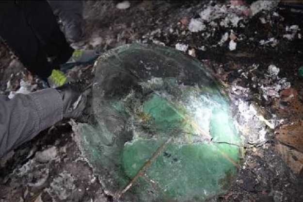 This is the plastic base of a natural tree that was never watered after decoration and ignited when a lit candle was placed too close to the tree.