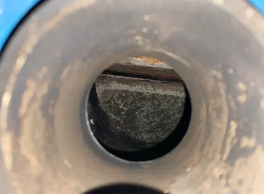 This flue pipe shows signs of residue from a boiler puffback.