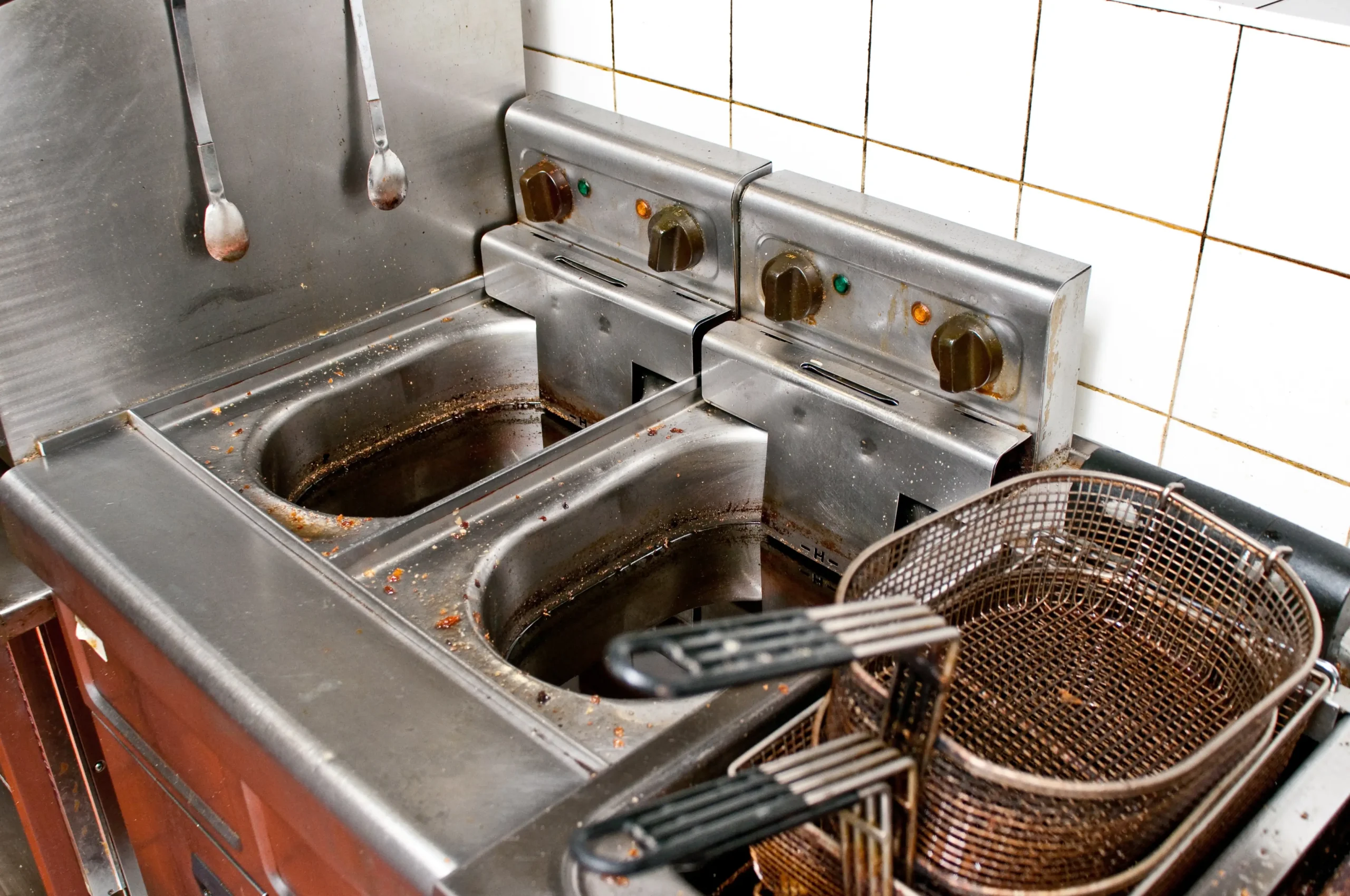 Cleaning grease residue from equipment is an important part of daily restaurant kitchen maintenance.