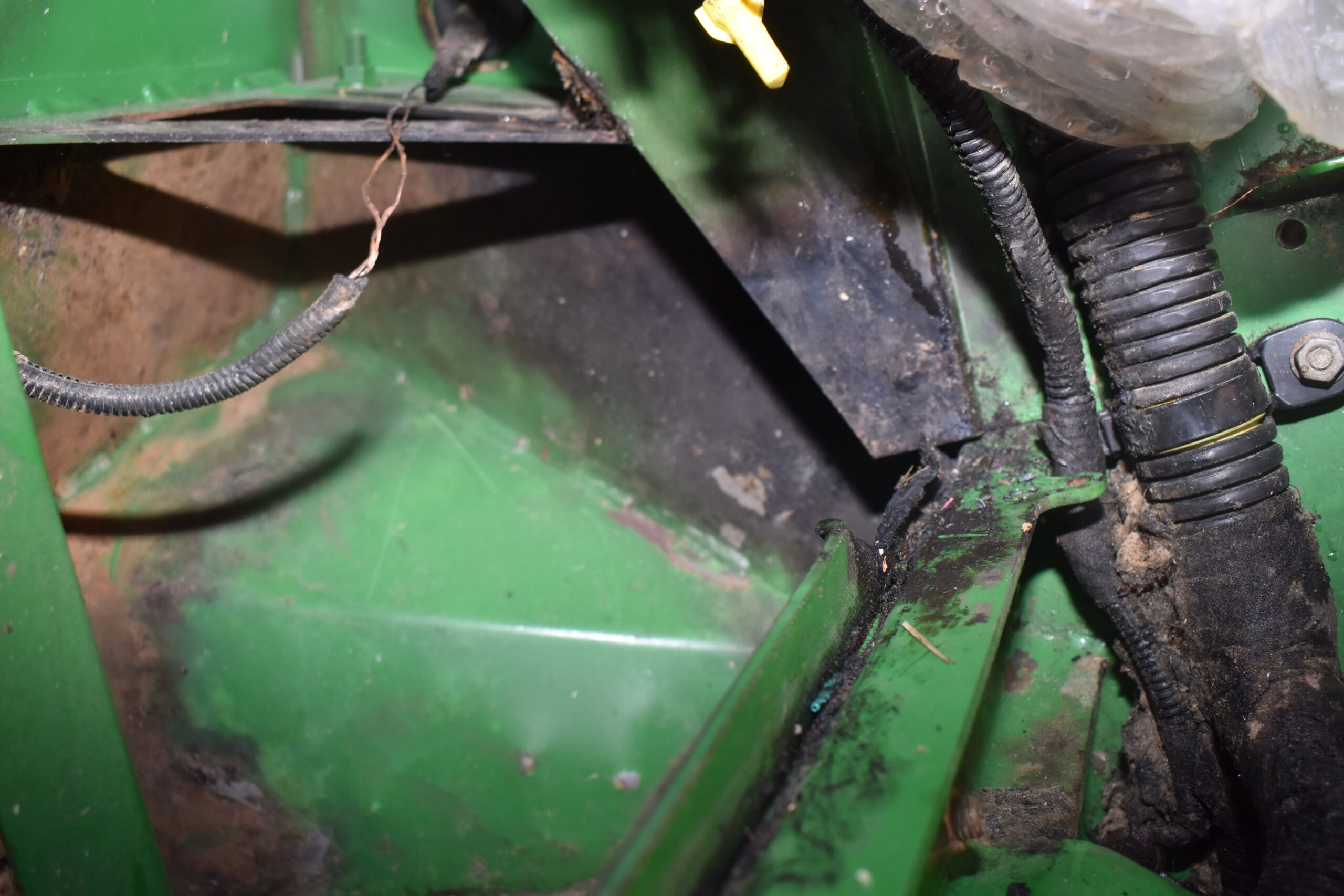 On this combine, a malfunctioning bearing overheated and lost physical integrity, causing metal-to-metal contact and sparking a flame and radiant heat that ignited grease.