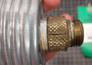 This image shows the detrimental effects of SCC on a brass coupling up-close.