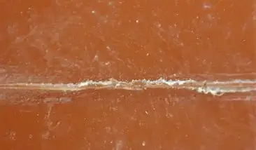 This image, captured at Component Testing Laboratories (CTL), provides a close-up view of longitudinal fractures in PEX tubing, caused by oxidative degradation stemming from a manufacturer's defect.