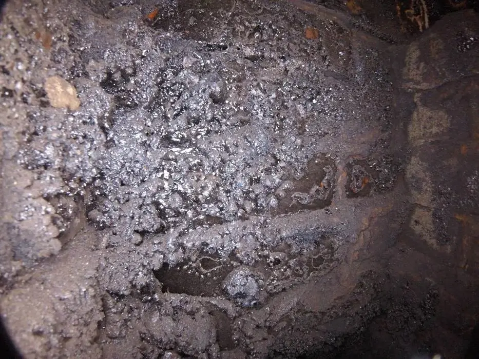 Creosote has built up inside this smoke chamber over time.