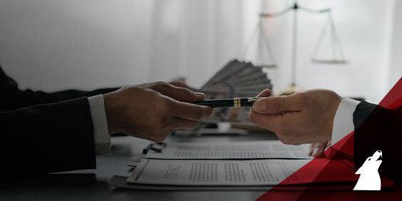 Two individuals are presenting money at a desk, likely engaged in a financial conversation or transaction.