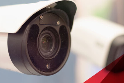 Close-up image featuring two security cameras, focusing on their structure and positioning for surveillance purposes.