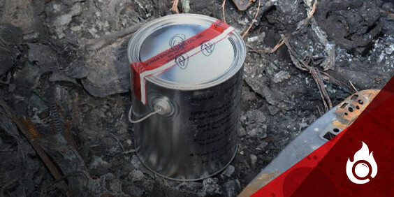 A can of gasoline lies on the ground adjacent to a knife, indicating a risky scenario involving flammable materials.