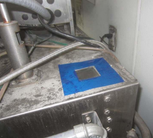 A metal container displaying a blue sticker on its exterior.