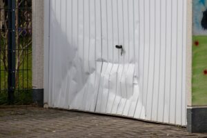 A dented white garage door