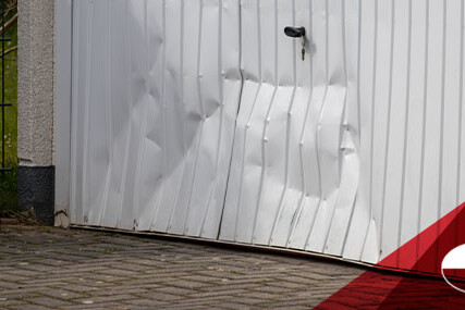 A dented white garage door