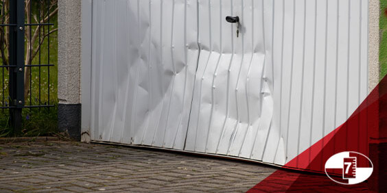 A dented white garage door