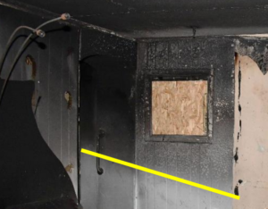 A yellow line marks the corners of a room where a fire damage is present