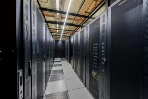 A data center hallway featuring multiple rows of servers