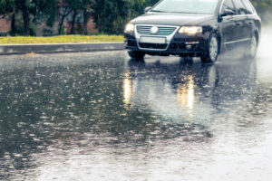 car is driving on the road during heavy rain