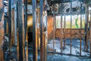 The interior structural remains of a home after a fire.
